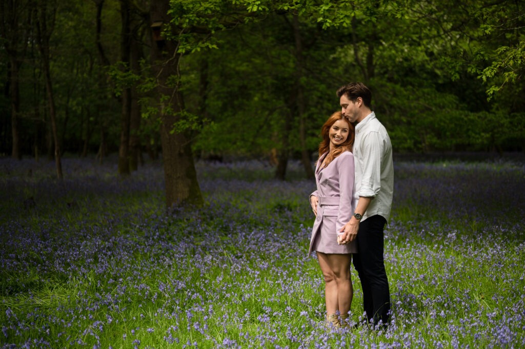 Springtime shot of couple in woods with bluebells