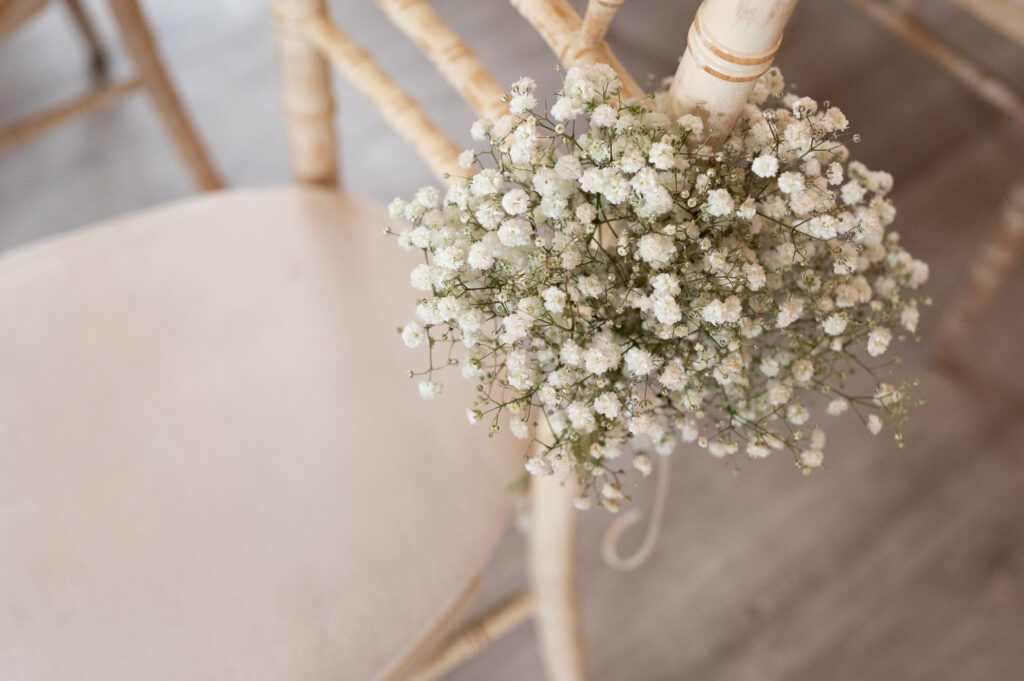 Wedding detail showing chair and flowers